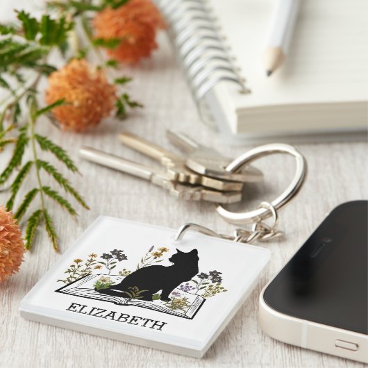 Schwarze Katze mit Blumenbuch Schlüsselanhänger (Vorderseite rechts)
