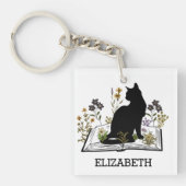 Schwarze Katze mit Blumenbuch Schlüsselanhänger (Vorderseite)