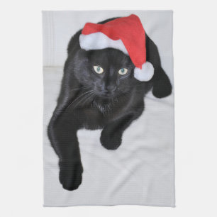 Schwarze Katze mit der roten Weihnachtsmannmütze Geschirrtuch