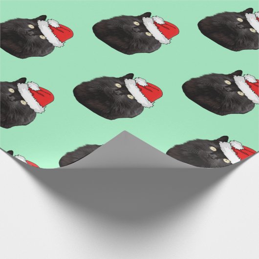 Schwarze Katze mit einer Weihnachtsmannmütze Geschenkpapier (Ecke)