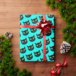 Schwarze Katze mit grünen Augen auf türkisblau Geschenkpapier