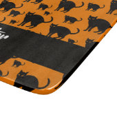 Schwarze Katzen auf Orange Schneidebrett (Ecke)