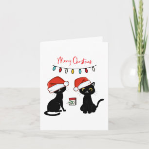Schwarze Katzen in Weihnachtsmannmützen Frohe Weih Karte