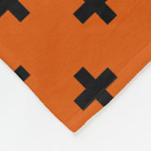 Schwarze Polka-Kreuze auf Orange Fleecedecke (Ecke)
