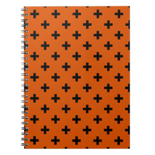 Schwarze Polka-Kreuze auf Orange Notizblock