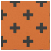 Schwarze Polka-Kreuze auf Orange Stoff (Nahaufnahme)