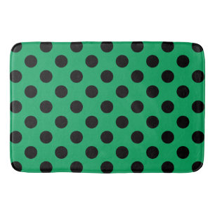 Schwarze Polka Punkte auf frisch grünem Badematte