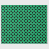 Schwarze Polka Punkte auf frisch grünem Geschenkpapier (Flach)