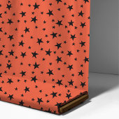 Schwarze Sterne auf orangefarbenem Halloween-Party Stoff