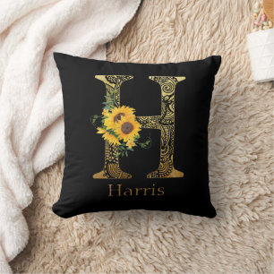 Schwarze und goldene Sonnenblumen mit dem Buchstab Kissen