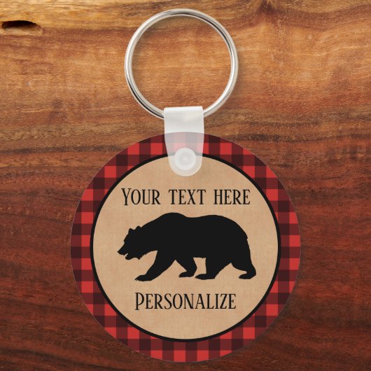 Schwarzer Bär auf einem roten und schwarzen Karier Schlüsselanhänger (Rückseite)