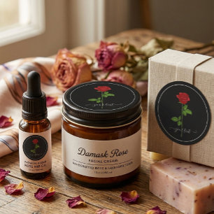 Schwarzer runder Aufkleber mit roter Rose und indi