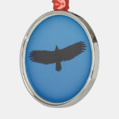 Schwarzer Vogel in einem blauen Himmel Silbernes Ornament (Links)