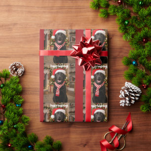 Schwarzes Lab-Tatzenabdruck-Muster Frohe Howlidays Geschenkpapier