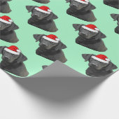 Schwarzes Labrador in einer Weihnachtsmannmütze Geschenkpapier (Ecke)