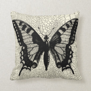 Schwarzweiss-Schmetterling auf gebrochenem Kissen