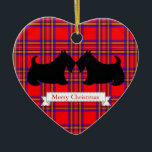 Scottish Terrier Christmas Ornament<br><div class="desc">Schwarze schottische Terrier gegen ein rotes kariertes Muster schmücken dieses Urlaubssornament. Nutzen Sie dieses niedliche Kunsthandwerksdekor als Weihnachtsbaumdekoration,  Feriendekoration,  Weihnachtsdekoration,  etc... .Die Designs stammen aus der Originalkunst.</div>