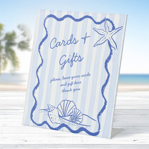 Seashells Hochzeitsgeschenke an der blauen Grenze Sockelschild