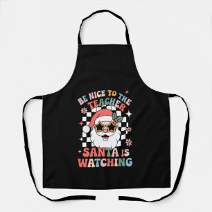 Sei nett zu dem Lehrer, der Weihnachtsmann beobach Schürze
