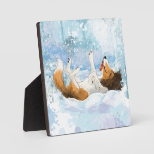 Sheldon der Sheltie spielt im Schnee Fotoplatte