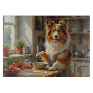 Shetland Sheepdog kocht in der Küche Schneidebrett