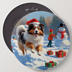 Shetland Sheepdog läuft durch Schnee mit Weihnacht Button