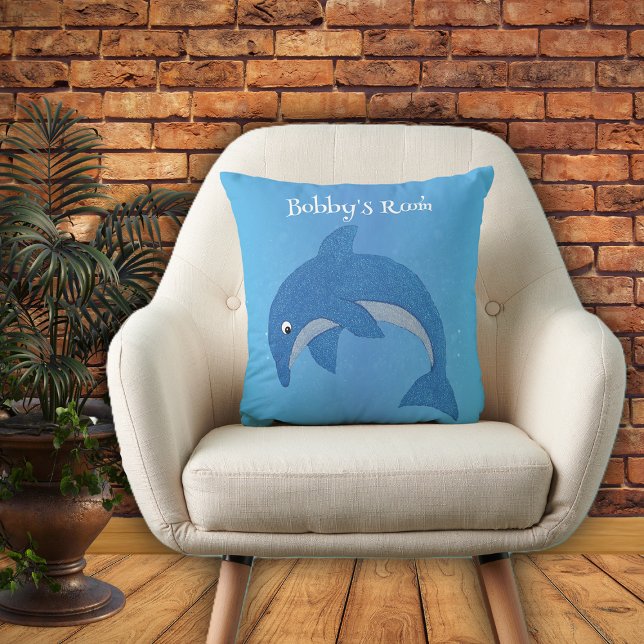 Shiny Cartoon Blue White Jumping Dolphin auf Blue Kissen (Bright blue throw pillow with cute jumping dolphin in dark blue and white for kids bedroom.)