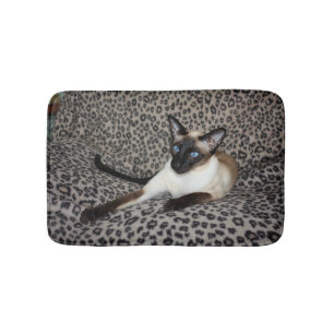 Siamesische Katze auf Leopard-Druck-wildes Badematte