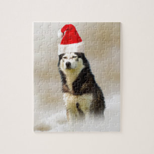 Siberischer Husky-Hund mit Weihnachtsmannmütze im Puzzle