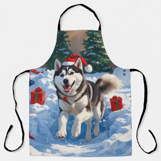 Sibirischer Husky läuft im Schnee mit Weihnachtsmü Schürze (Vorderseite)