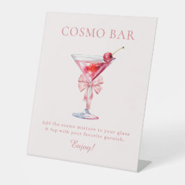 Sie bindet das Knot-Pink-Coquette-Cosmo-Bar Sockelschild
