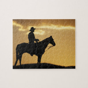 Silhouette des Cowboys auf Pferden bei Sonnenunter Puzzle