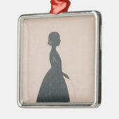 Silhouette eines Mädchens mit einem Silbernes Ornament (Links)