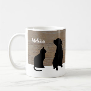 Silhouetten der schwarzen Katze Hundeauf hölzernem Kaffeetasse
