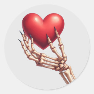 Skeleton Hand Rotes Herz anheben Runder Aufkleber