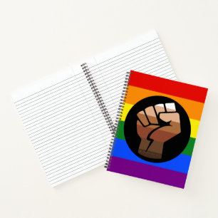 SlipperyJoes Regenbogenflagge mit erhobener Faust Notizblock