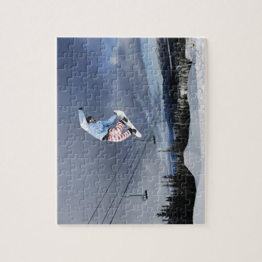 Snowboarder springen in der Luft und machen eine H Puzzle (Vertikal)