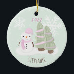 Snowman Christmas Keramik Ornament<br><div class="desc">Snowman Christmas Celebrate your child's winter birthday with this cute and snowman wearing a pastel pink knitted hat and scarf. This theme is ideal for your little one’s winter birthday or kid’s Christmas party. Design is completely customizable. Check out the coordinating stationery and ohrs.</div>