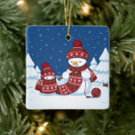 Snowman Knitting Christmas Scarf Keramikornament<br><div class="desc">Cartoon illustration of two adorable snowmen dressed in knitted hats and scarves. The big snowman is knitting an oversized scarf for the little one. The scarf is already wrapped several times around the cute little snowman.</div>