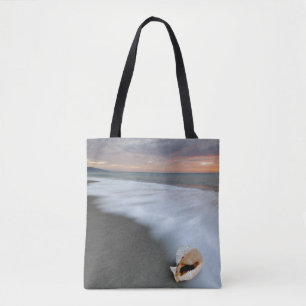 Sonnenaufgang auf dem Strand und einer Muschel Tasche