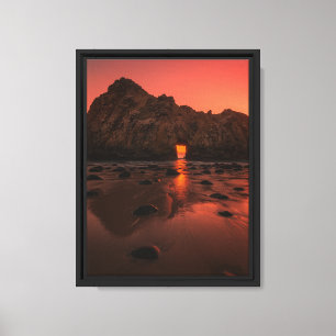 Sonnenuntergang glühen durch den Felsbogen am Meer Leinwanddruck