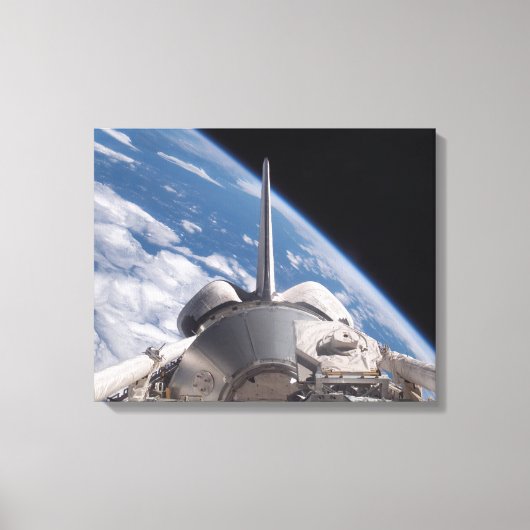 Space Shuttle Discovery im Hintergrund Leinwanddruck (Vorderseite)