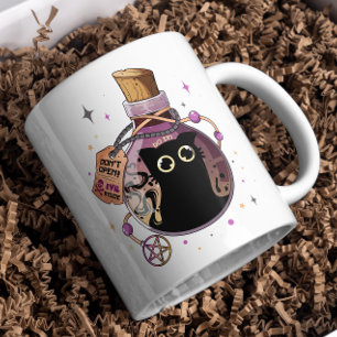 Spielendes böses Katzenmonster in Tränenflasche ge Kaffeetasse
