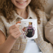 Spielendes böses Katzenmonster in Tränenflasche ge Kaffeetasse