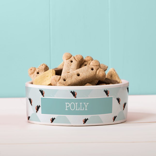 Spielerische Pinguine, die auf dem Schneepattern g Napf (Penguin pattern pet bowl)