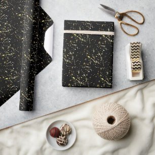 Spritzer mit Goldfarbe auf schwarz Geschenkpapier