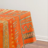 Stammes- ethnisches Mustergold auf Leuchtorange Tischdecke (Beispiel)