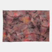 Steine in roten Farbtönen auf schwarz-grauem Hinte Geschirrtuch (Horizontal)