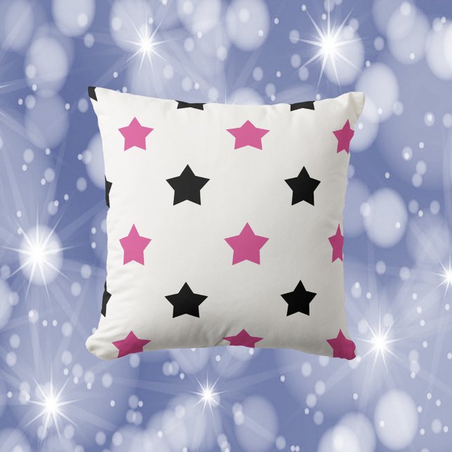 Sterne Schwarz-Rosa Muster Weiß Kissen (A throw pillow with a pattern of pink and black stars.)