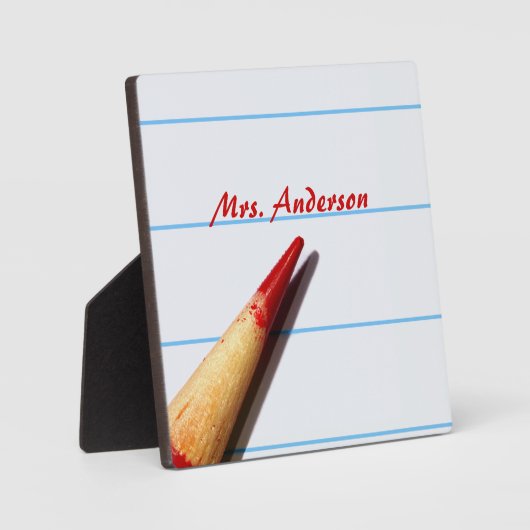 Stift des roten Lehrers auf gestrichenem Papier mi Fotoplatte (Vorderseite)
